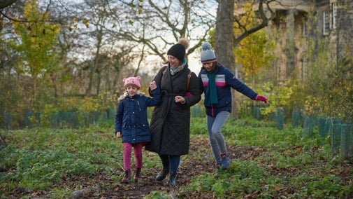 Family enjoying the Follow The Star Christmas trail in the garden at Seaton Delaval Hall, Northumberland